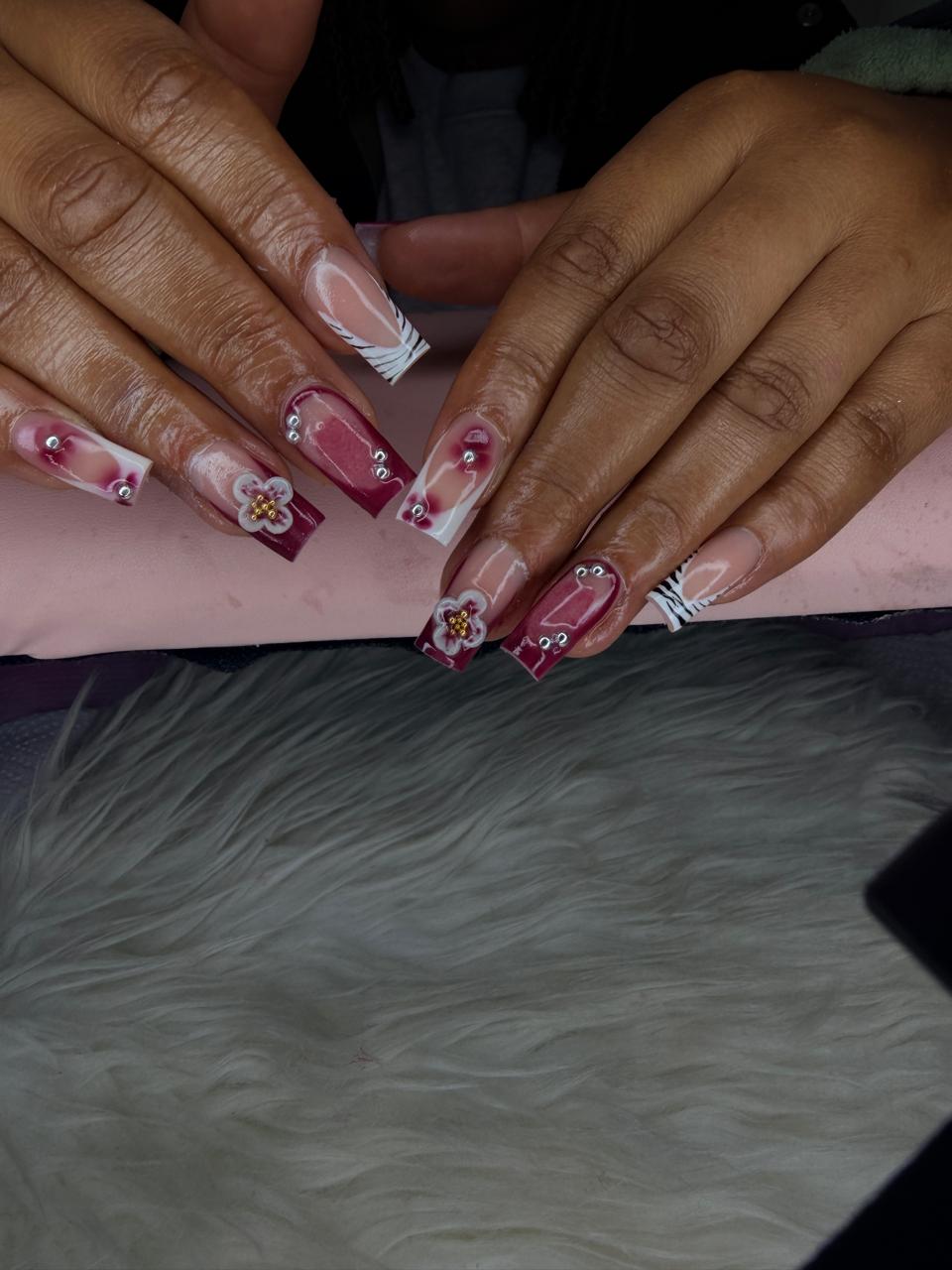 Burgundy rhinestone floral nail art